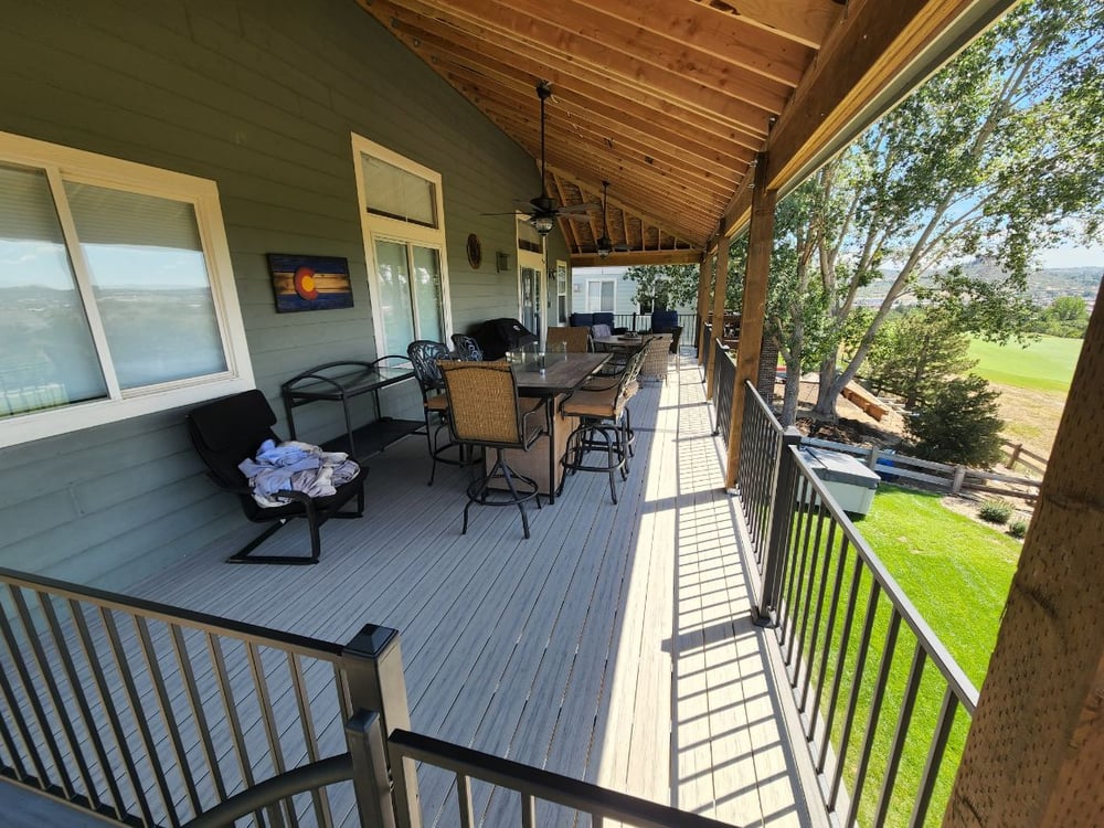 Long covered deck in Colorado Springs with angled roofing by Black Diamond Decks