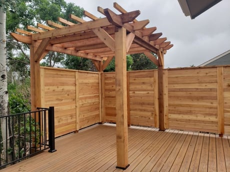 Wood privacy fence with pergola over deck