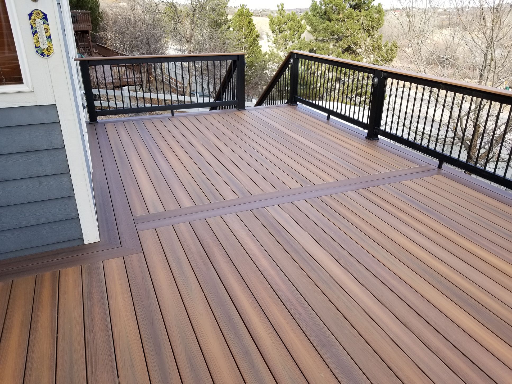 warm brown deck with black railing