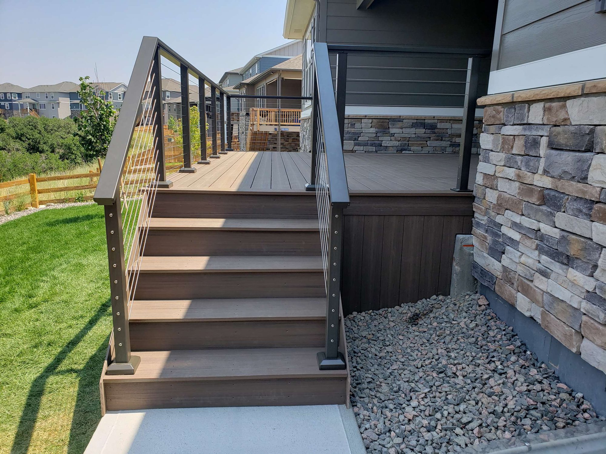 deck with stairs and railing