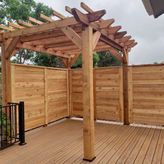 Light Brown Wooded Pergola in Front of Similarly Colored Wood Walls
